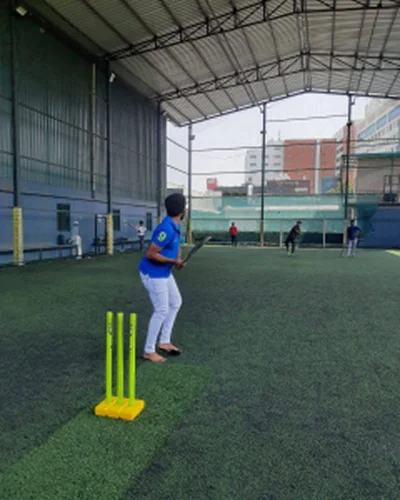 Batting at an indoor cricket net